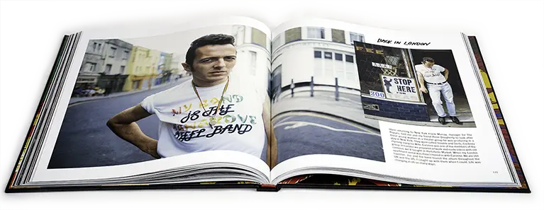 Colour photo of an open double page of Print the Myth: Joe Strummer Portraits 1981–2002 by Josh Cheuse